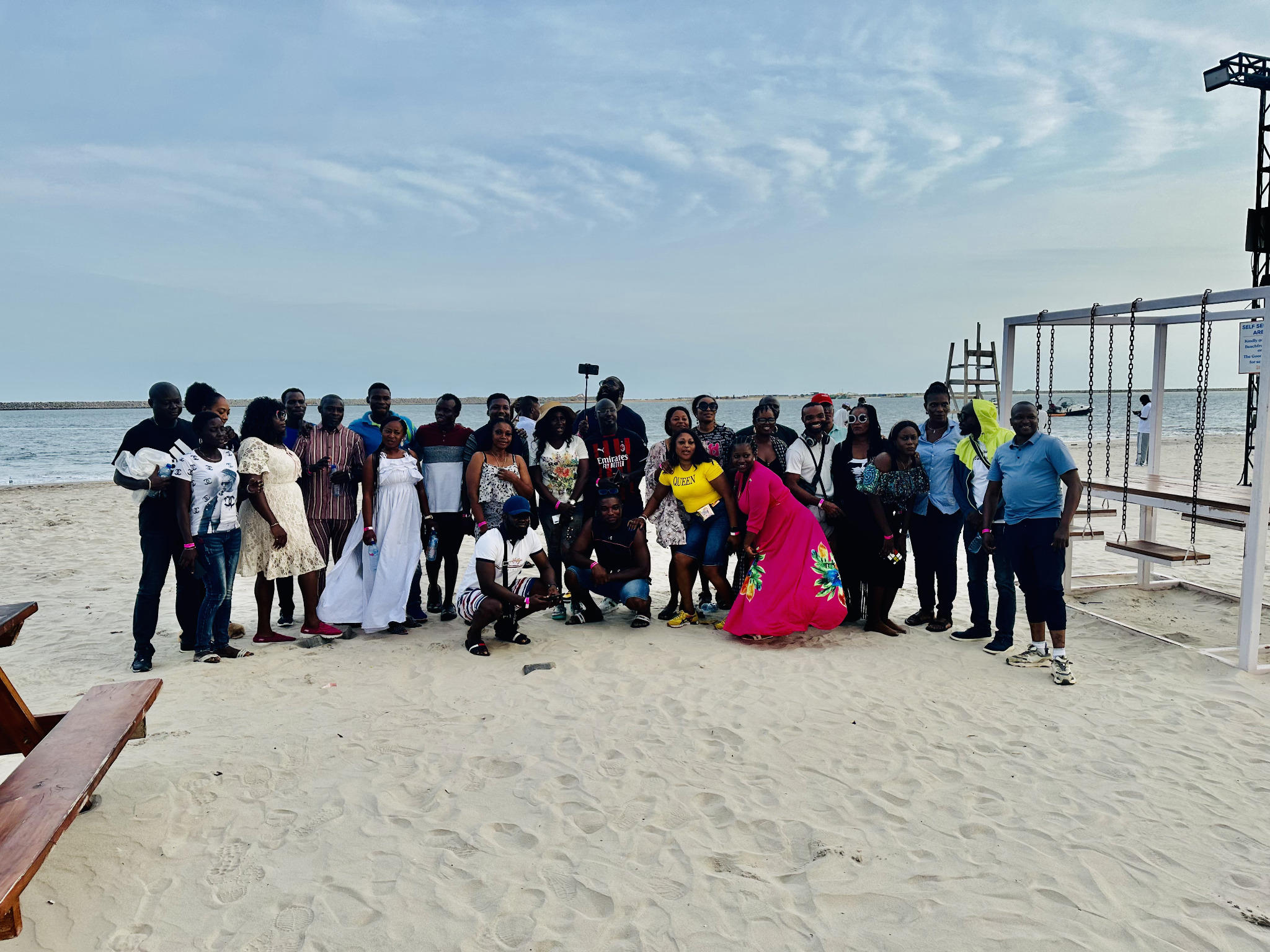 Classmates during a group photograph on the beach