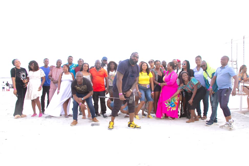 A large group photograph on the beach