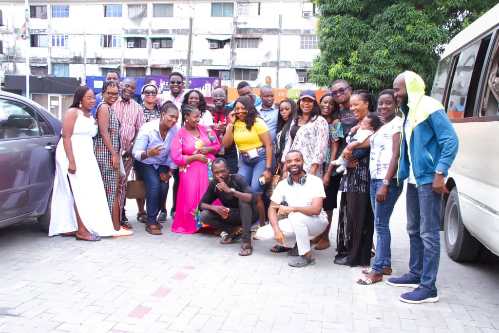 Classmates during a group photograph outdoors