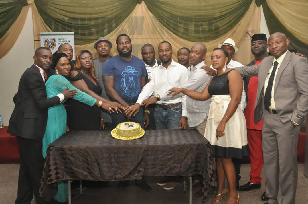 Members cutting the celebration cake at the First End-of-Year Party, 2016 (photograph 1 of 4)
