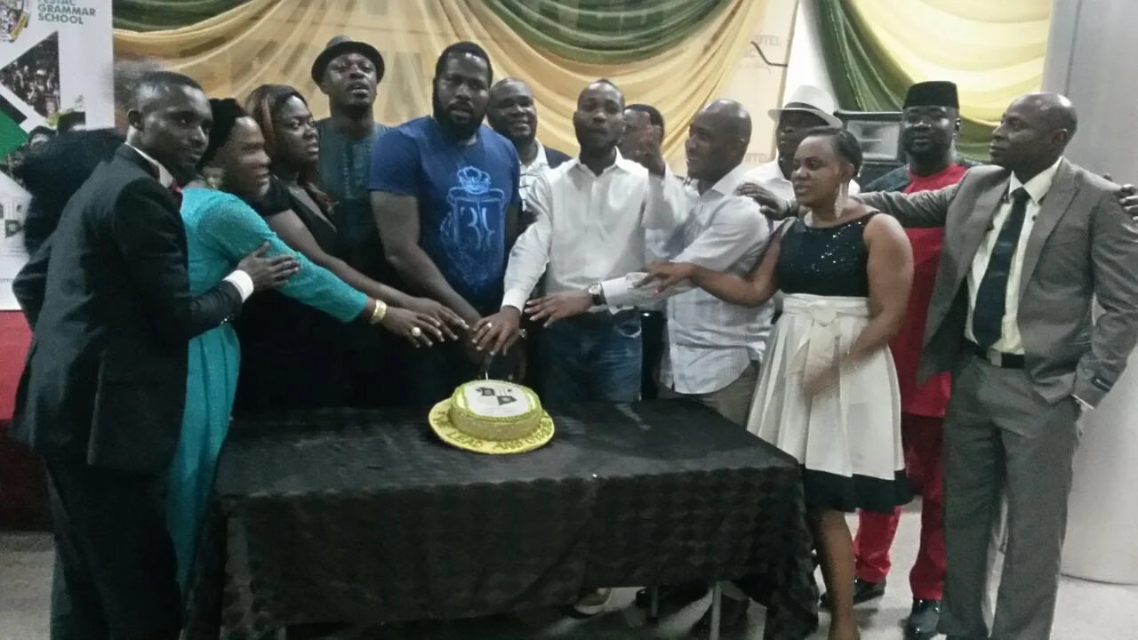 Members cutting the celebration cake at the First End-of-Year Party, 2016 (photograph 2 of 4)