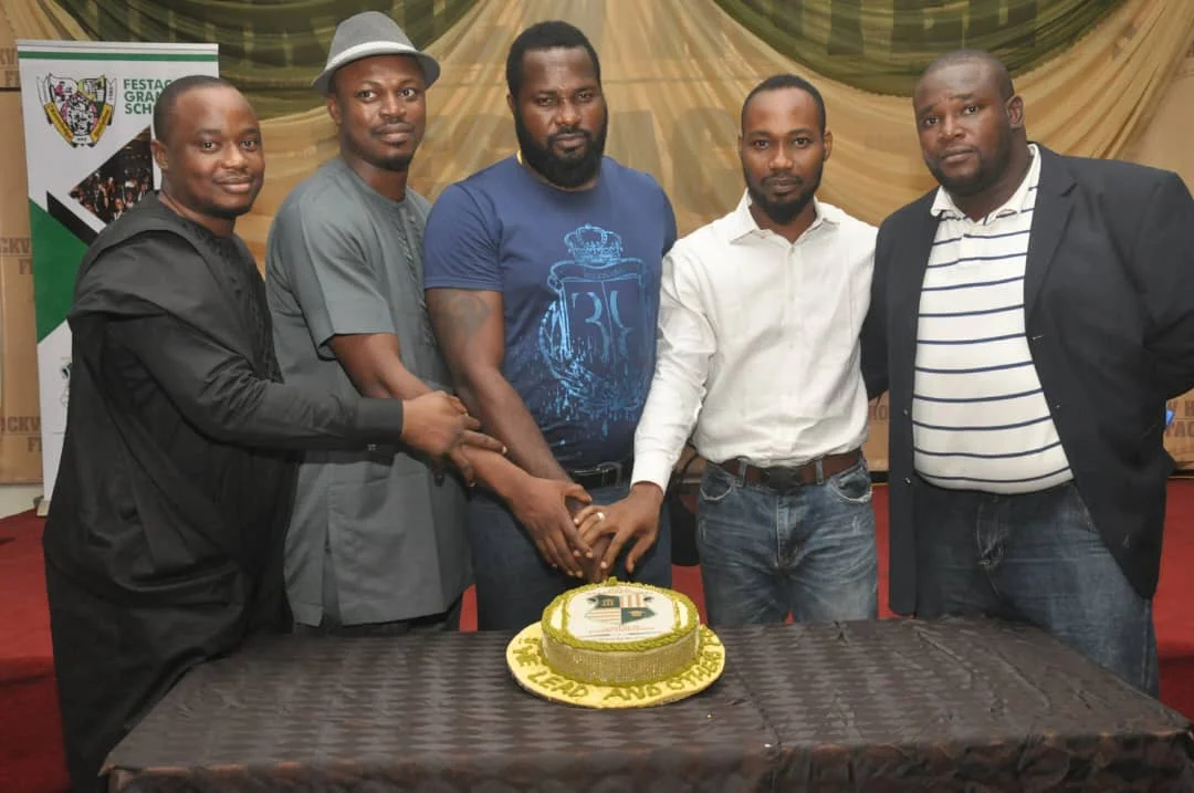 Members cutting the celebration cake at the First End-of-Year Party, 2016 (photograph 3 of 4)