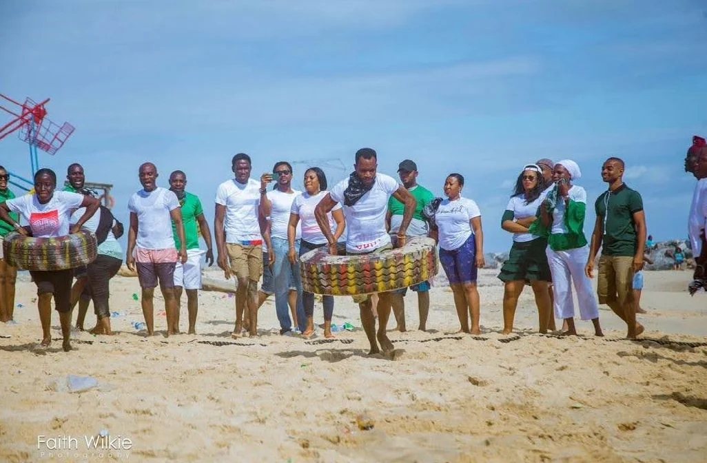 Members taking part in a tyre game on the beach, 2019 (photograph 1 of 3)