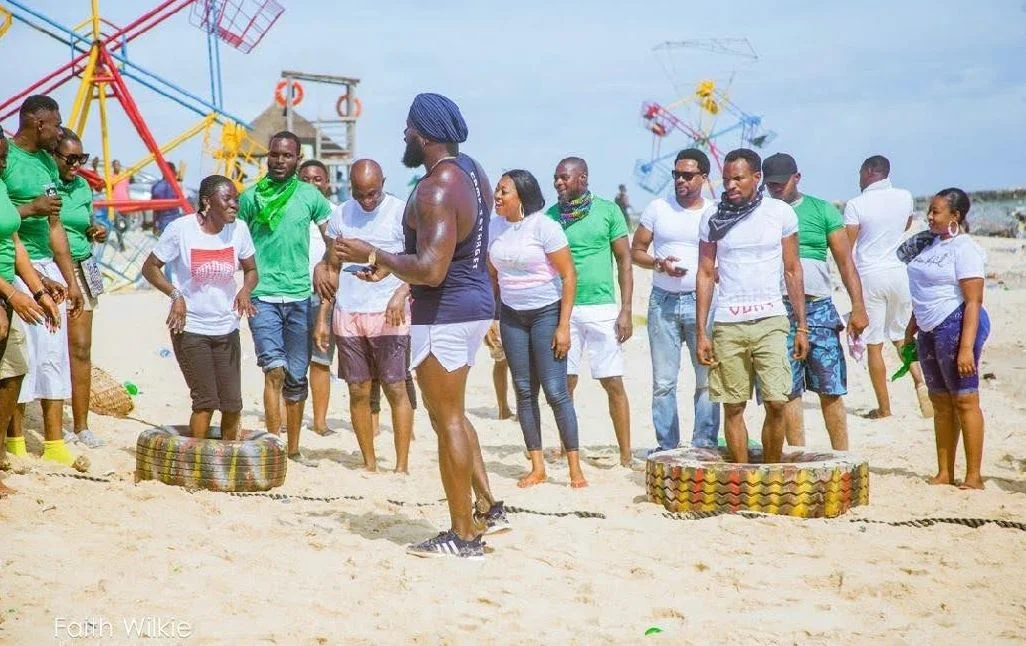 Members taking part in a tyre game on the beach, 2019 (photograph 2 of 3)