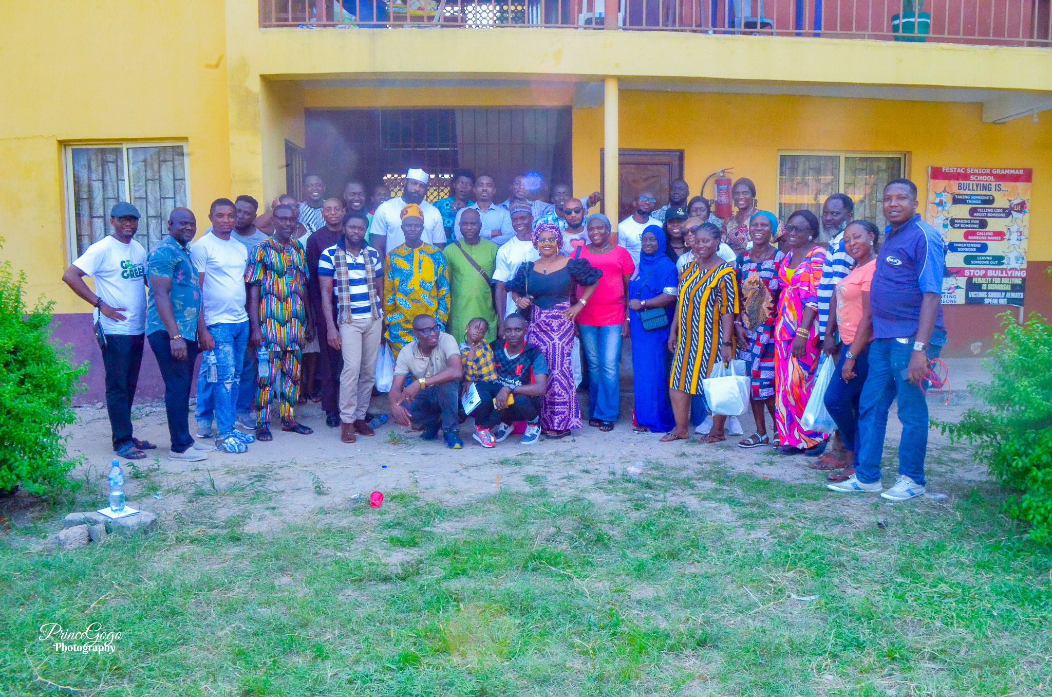 Alumni members standing together in a school courtyard