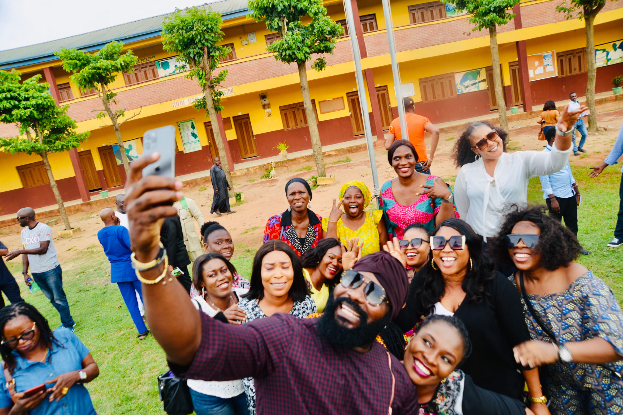 Classmates taking a group selfie on school grounds