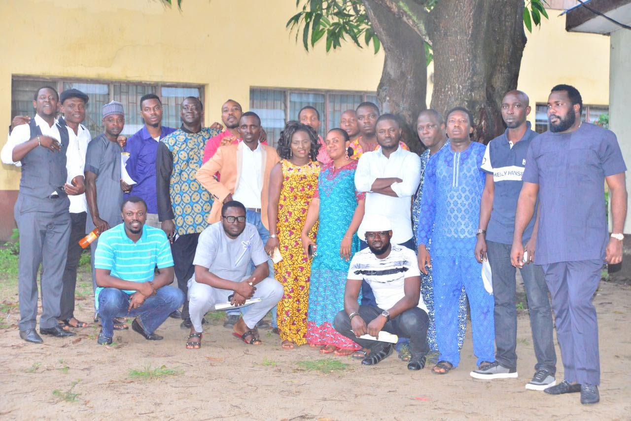 Alumni group portrait in a school courtyard