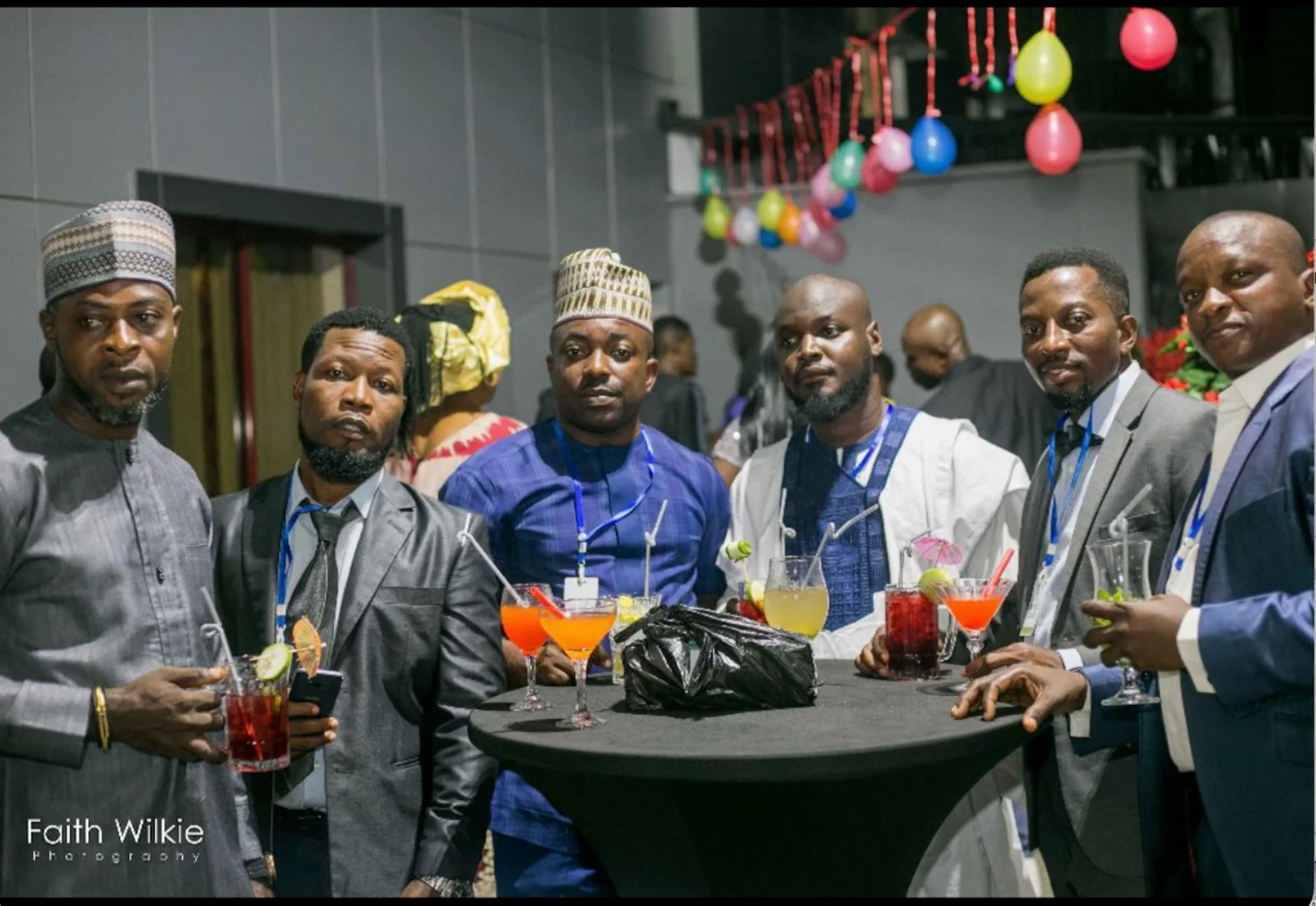 FGSCAA members gathered around a cocktail table with drinks during the evening programme of the 2020 Homecoming.