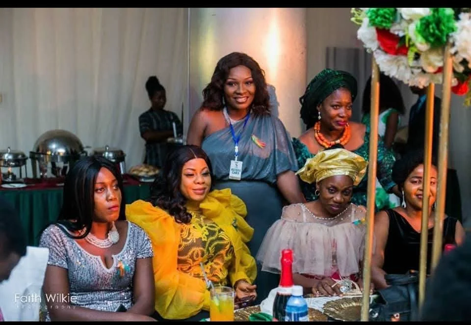 FGSCAA members seated and standing around a table during the social and networking programme of the 2020 Homecoming.