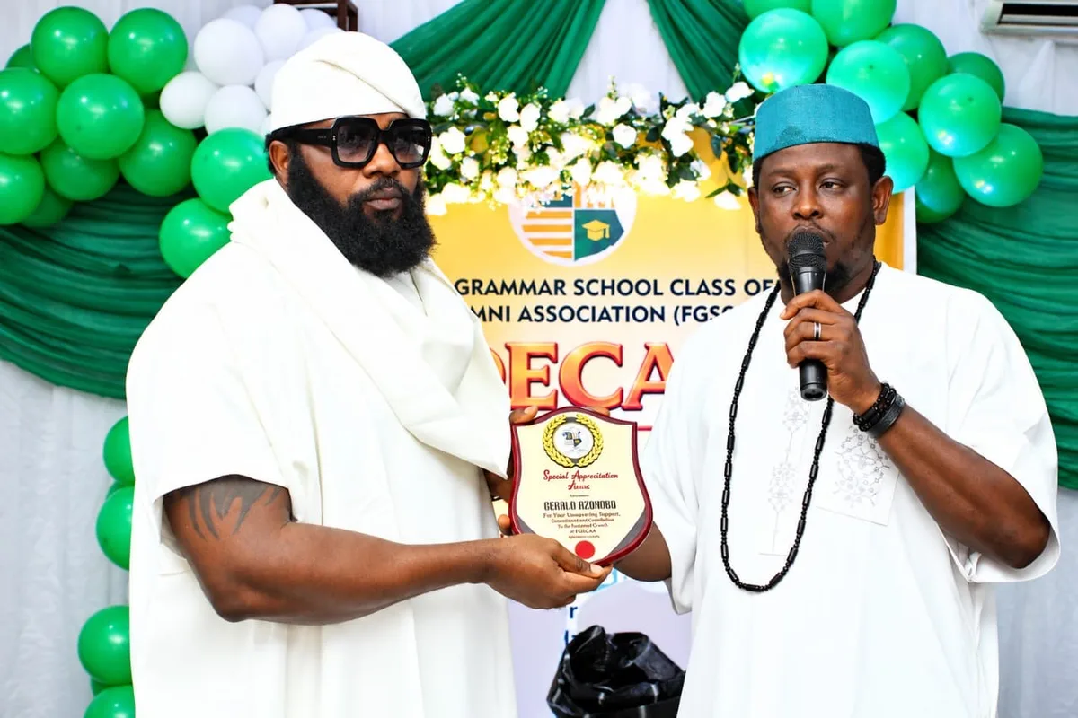 A Special Appreciation Award plaque being presented between two members in white attire in front of the FGSCAA anniversary backdrop, one holding a microphone