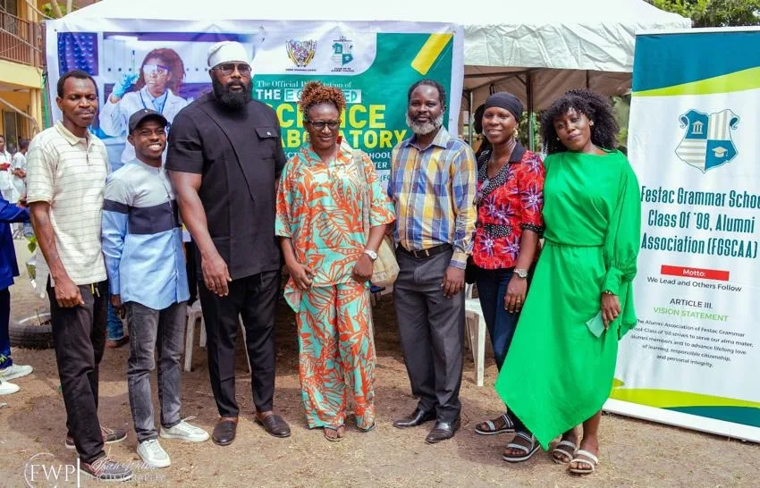 Seven FGSCAA members and representatives pose together in front of event banners, including the FGSCAA vision-statement banner.