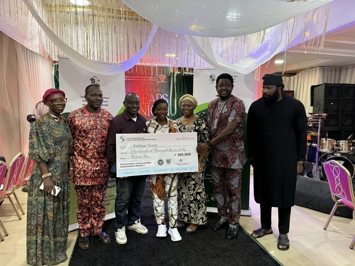 FGSCAA members presenting a ₦100,000 tuition-fee award cheque to scholarship beneficiary Adebayo Susan.