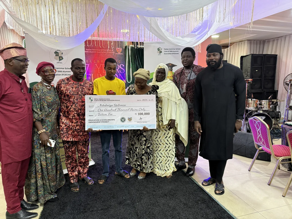 FGSCAA members and family presenting a ₦100,000 tuition-fee award cheque to a scholarship beneficiary.