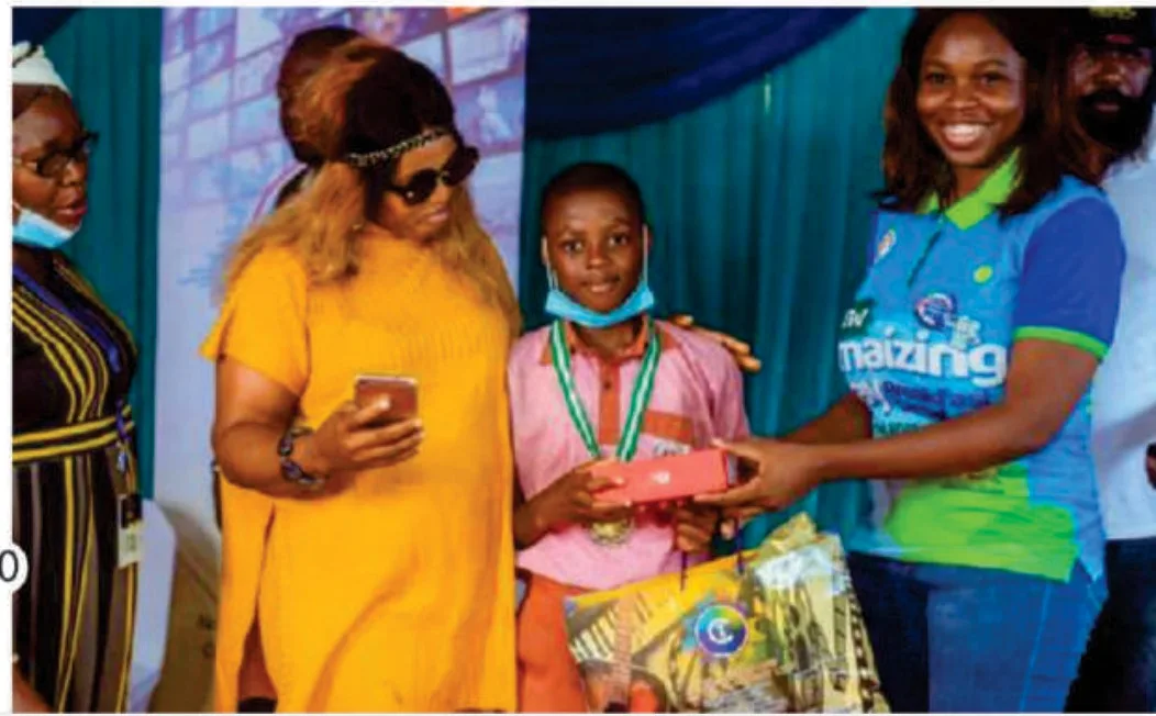 A medal-wearing student receiving a prize during one of the award presentations at the 2021 FGSCAA Spelling Bee.