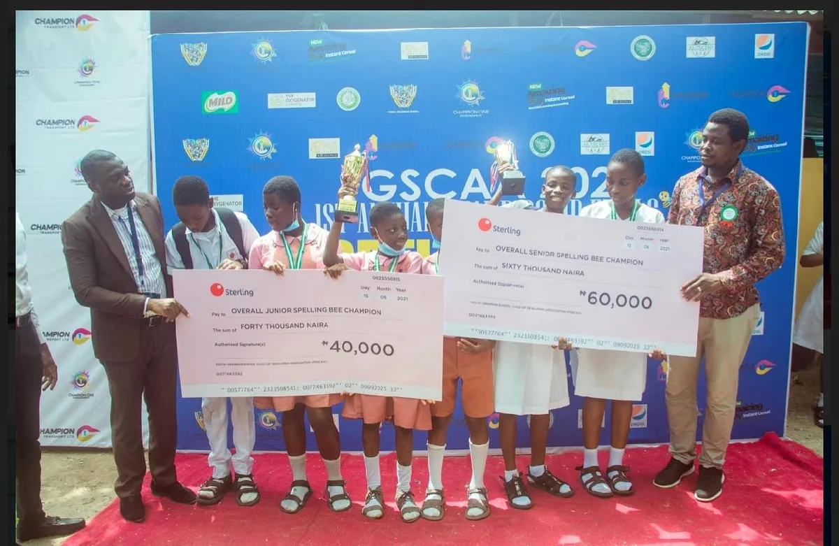 Junior and Senior award recipients holding trophies and prize cheques at the 2021 FGSCAA Spelling Bee.